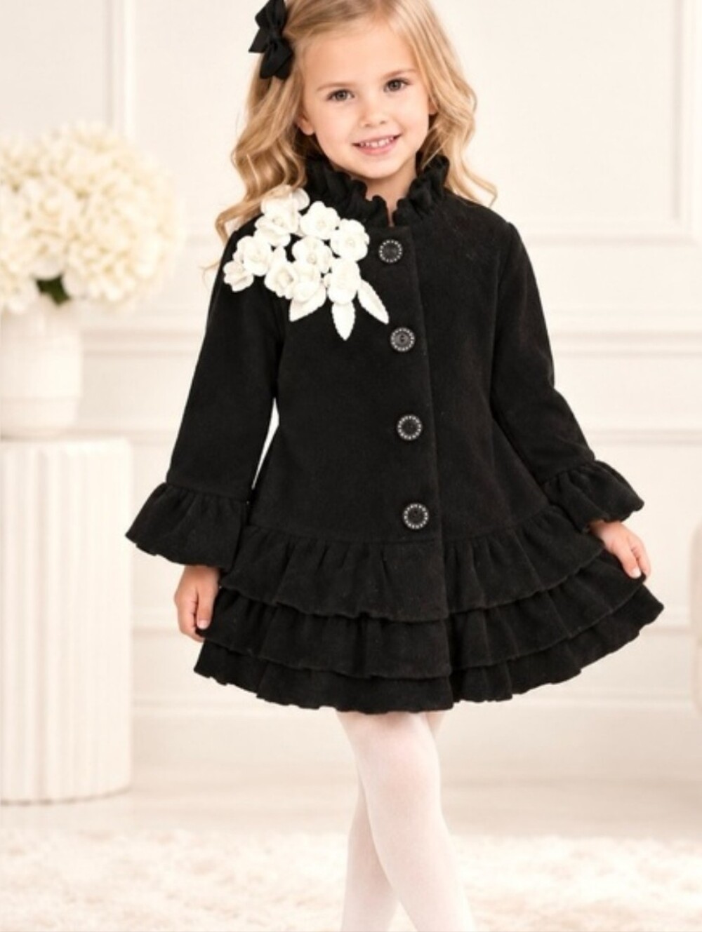 Mack & Co fleece black coat with layered ruffle hem and white floral fabric det